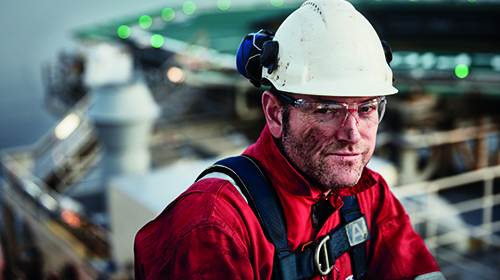 Worker at oil rig looking into the camera